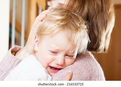 Mom Holding  Crying Child In Your Arms