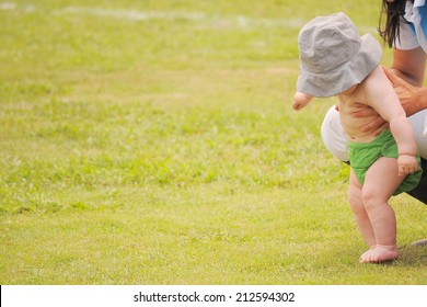 Mom Holding Little Baby Trying To Walk