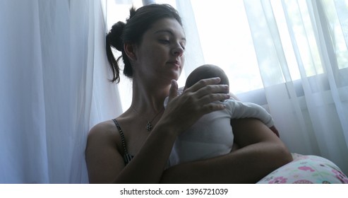 Mom Holding Newborn Baby Son In Her Arms, Real Life And Candid Family Moment