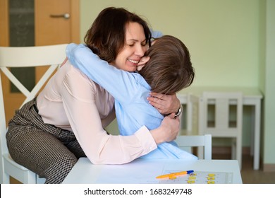 Mom Hug Son To Do Homework. The Teacher Deals With A Boy.