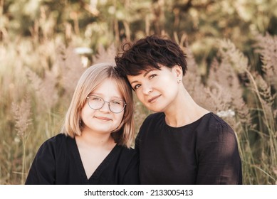 Mom Hugging Daughter Teenager On A Background Of Nature