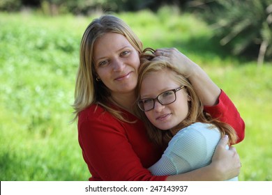 Mom Hugging Daughter Teenager On A Background Of Nature