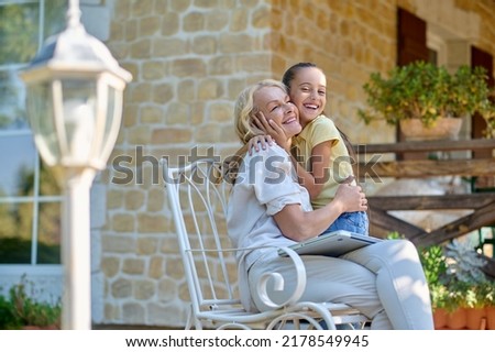 Similar – Woman carrying her mother in a wheelchair