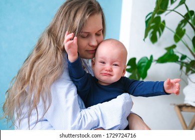 Mom Hugs Crying Moody Kid Tantrum. Little Baby Child On Mother Hands. Family Life, Motherhood.