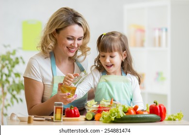 Mom And Kid Girl Preparing Healthy Food At Home