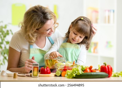 Mom And Kid Girl Preparing Healthy Food At Home