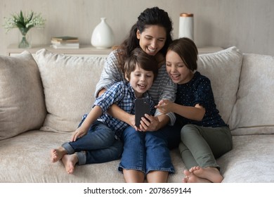 Mom And Kids Look At Cell Phone Screen Laughing Watch Funny Video, Play Cool Amusing Online Game, Having Pleasant Conversation With Family Through Videocall Application, Modern Tech Usage, Fun Concept