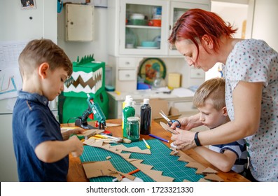 	
Mom And Kids Making A Cardboard Dinosaur Costume	
