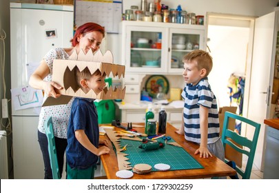 Mom And Kids Making A Cardboard Dinosaur Costume