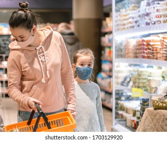 Mom And Kids Are Shopping At The Grocery Store. They Wear Masks During Quarantine. Coronavirus Pandemic .COVED-19 Flash. The Epidemic Of The Virus