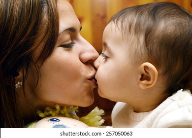 Mom Kissing And Hug Baby