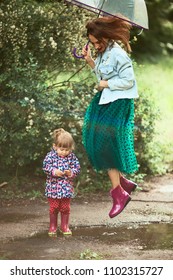 Mom And Little Kid Jump On The Pools After Rain