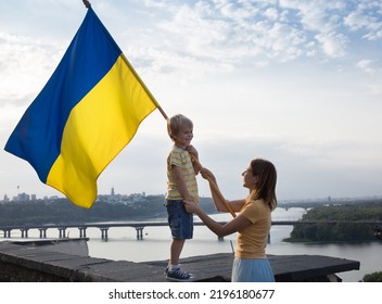 Mom   little son stand high the roof the house against the background the sky   the Dnieper River in Kyiv  Patriotism  drawing attention to the war in Ukraine  Support Ukraine