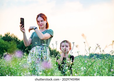 Mom Looks At The Phone And The Child Plays By Himself