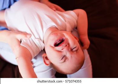 Mom makes massage a child who whimpers in pain