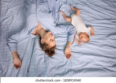 Mom And Newborn Sleep Together In The Bedroom On The Bed. Joint Sleep Concept. Tired Parent. Natural Parenting Care. Silence Is Calm. Motherhood Baby Togetherness. Real Life Lifestyle