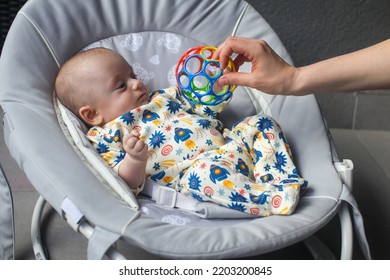 Mom Offering An Oball To Her 2 Months Old Baby