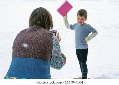 Mom Photographs Her Son In Winter, Photo Of A Child On The Phone On A Snow Background