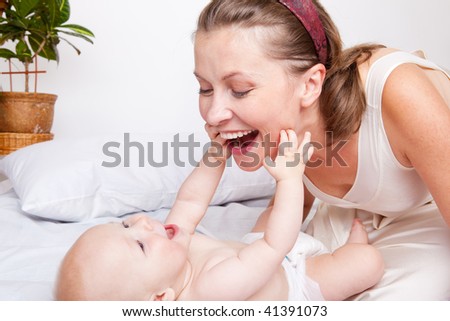 Mom playing with her cute baby