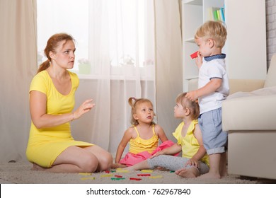 Mom Plays With Children Twins In The Room, Mom Scolds Her Son For A Bad Deed.