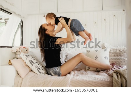 Similar – Relaxed mother and sons playing over the bed