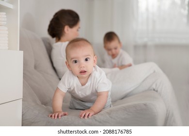 Mom Plays And Reads Books With Two  Little Kids. Mother Spends Time With Two Child Sons At Home.  Place For Text. Copy Space. Family Time At Home
