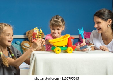 Mom Plays With Two Daughters In A Self-made Finger Puppet Theater