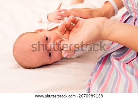 Mom prepare her newborn baby to breastfeed
