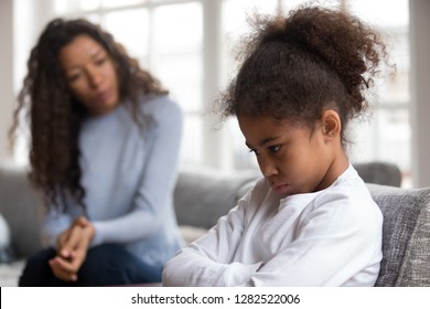 Mom or psychologist talking counseling upset offended african american child girl feels sad insulted, sulky frustrated black mixed race kid daughter having psychological trauma depression problem - Shutterstock ID 1282522006