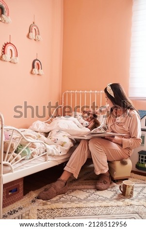 Similar – Happy boy jumping and playing over the bed with his family in a relaxed morning. Weekend family leisure time concept.