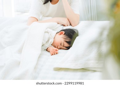 Mom putting baby to sleep. - Powered by Shutterstock