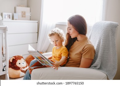 Mom Reading Book With Baby Boy Toddler At Home. Early Age Children Education Development. Mother And Child Kid Spending Time Together. Family Authentic Candid Lifestyle. 