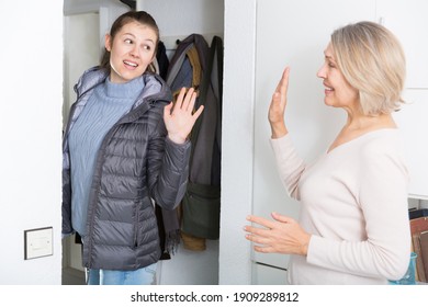 Mom Says Goodbye To Her Daughter In The Hallway Of The Apartment. High Quality Photo