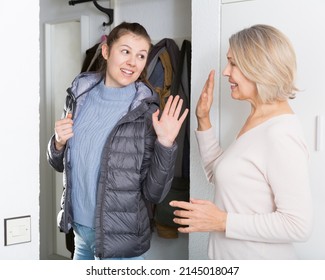 Mom Says Goodbye To Her Daughter In The Hallway Of The Apartment. High Quality Photo