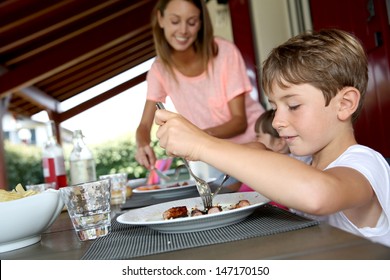 Mom Serving Grilled Food To Children