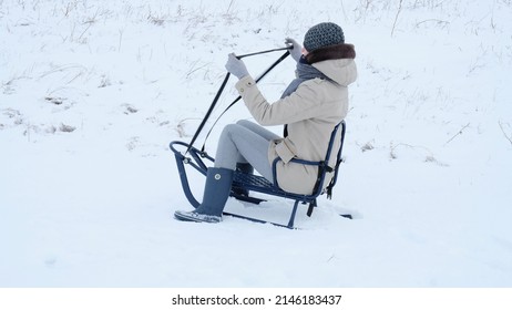 Mom Sledding In The Snow.  Strange Girl