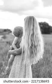 Mom And Son Are Admiring The Sunset. Mom Hugs Her Son. The Son Is Interested In The Sky.