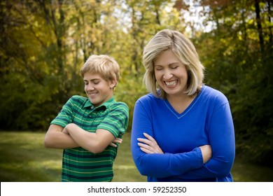 Mom And Son With Arms Crossed And Laughing