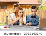 Mom and son are conducting chemical experiments at home. An experience with a child about creating a rocket launcher using a bottle, soda and vinegar.