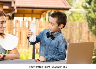 Mom And Son Are Conducting Chemical Experiments At Home. An Experience With A Child About Creating A Rocket Launcher Using A Bottle, Soda And Vinegar.