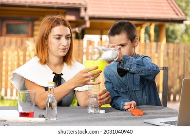 Mom And Son Are Conducting Chemical Experiments At Home. An Experience With A Child About Creating A Rocket Launcher Using A Bottle, Soda And Vinegar.