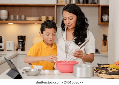 Mom and son cooking cooking at home -mom teaching her son to cook-happy family in the kitchen-mothers day - Powered by Shutterstock