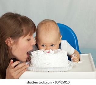 Mom and son eating birthday cake.