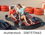 Mom and son have fun and go karting. Joint leisure for two and motorsport classes