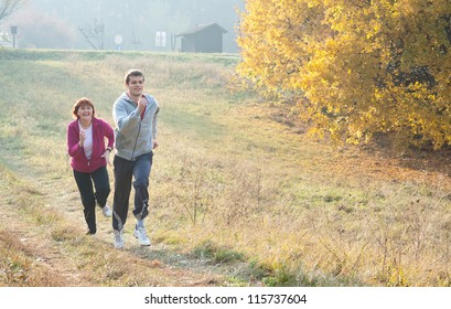 Mom And Son Jogging In A Meadow