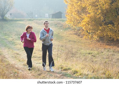 Mom And Son Jogging In A Meadow