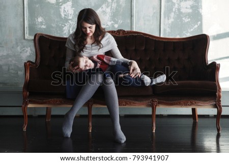Mom And Son On An Old Sofa Mom And Son On An Old Sofa