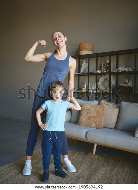 mom\
and son play sports at home. a smile on their\
faces.