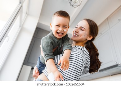 Mom And Son Playing At Home.