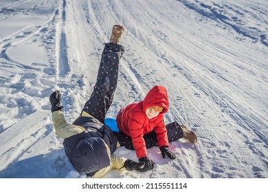 Mom And Son Sledding On The Mountain